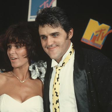 Jay Leno (with his wife, Mavis) is clearly mesmerized by something. The rich mine of jokes regarding Godley & Creme's Video of the Year nomination for 1986 VMAs "Cry," perhaps?