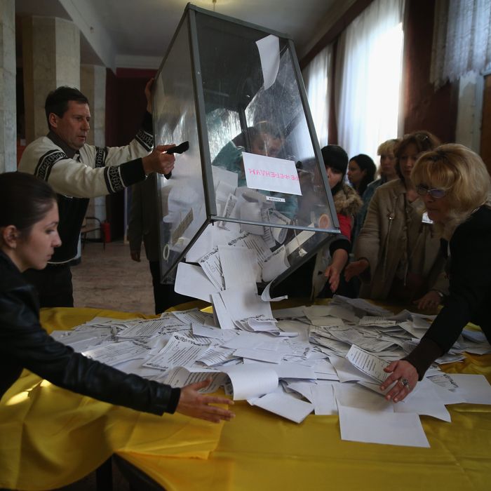 SLOVYANSK, UKRAINE - MAY 11: Election workers dump a ballot box to count votes following eastern Ukraine's sovereignty referendum on May 11, 2014 in Slovyansk, Ukraine. Pro-Russian communities in eastern Ukraine staged the vote in defiance of federal and international pressure. (Photo by John Moore/Getty Images)