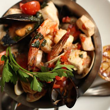 With roasted tomato broth, shrimp, mussels, clams, market-fresh fish, and grilled sourdough bread