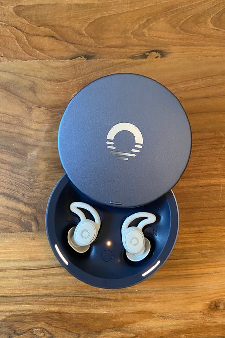 A pair of headphones in a case, on a table.