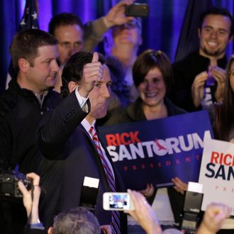 Republican presidential candidate, former Pennsylvania Sen. Rick Santorum gestures to supporters as he enters his victory party Tuesday, Jan. 3, 2012, in Johnston, Iowa. (AP Photo/Charlie Riedel)