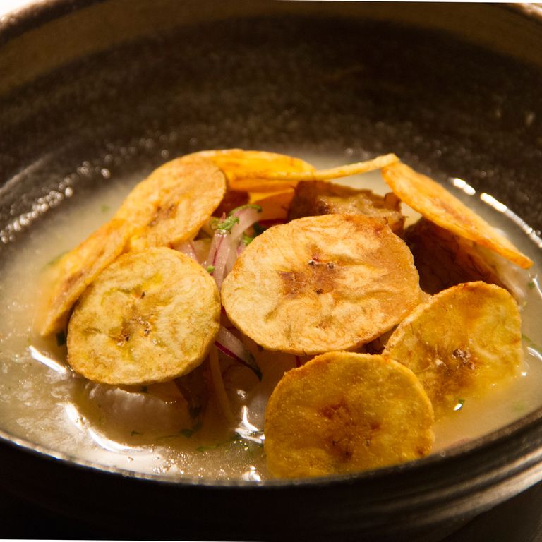 Corvina ceviche with bits of sweet fried plantain lies under a dome of crisp plantain chips.
