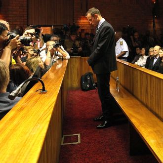 Olympic athlete Oscar Pistorius stands in the dock during his bail hearing at the magistrates court in Pretoria, South Africa, Friday, Feb. 22, 2013. The fourth and likely final day of Oscar Pistorius' bail hearing opened on Friday, with the magistrate then to rule if the double-amputee athlete can be freed before trial or if he has to remain in custody over the shooting death of his girlfriend.