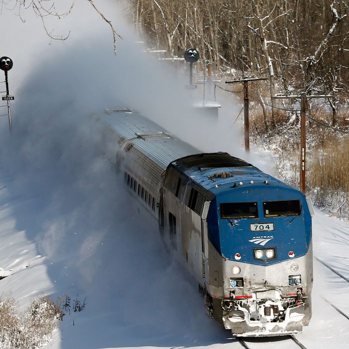 An Amtrak train kicks up fresh snow as it speeds southbound on Friday, Jan. 3, 2014, in Schodack Landing, N.Y. The National Weather Service has posted winter storm warnings through Friday morning in most of the state. Temperatures are in the single digits or below zero, with the wind making it feel as cold as 20-30 below zero in some areas. (AP Photo/Mike Groll)