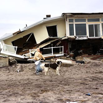 A woman walks with her dog by homes damaged by Hurricane Sandy along the beach in the Rockaways on January 15, 2013 in New York City. A $50.7 billion Superstorm Sandy aid package is expected to be voted on today in the House. The package, which has come under criticism by some fiscal conservatives, is being heavily pushed by Northeastern lawmakers. The money would be spent on immediate needs to the region including $5.4 billion for New York and New Jersey transit systems and $5.4 billion for the Federal Emergency Management Agency's disaster relief aid fund.