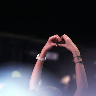 AUGSBURG, GERMANY - MARCH 19: A Justin Bieber fan forms a heart with her hands during the 'Wetten Dass ... ?' TV show at Augsburg fair ground on March 19, 2011 in Augsburg, Germany. (Photo by Johannes Simon/Getty Images)