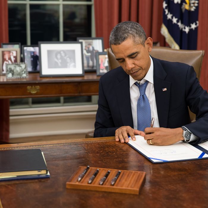 President Barack Obama signs H.R. 3210, Pay Our Military Act, which provides continuing appropriations for pay and allowances for members of the Armed Forces during any period for which interim or full-year appropriations for FY 2014 are not in effect, in the Oval Office, Monday night, Sept. 30, 2013.(Official White House Photo by Pete Souza)
