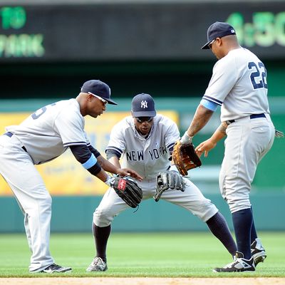 Dewayne Wise #45, Curtis Granderson #14 and Andruw Jones #22 of the New York Yankees celebrate after a 4-1 victory against the Washington Nationals at Nationals Park on June 17, 2012 in Washington, DC. 