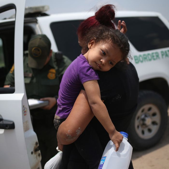  A mother and child, 3, from El Salvador await transport to a processing center for undocumented immigrants after they crossed the Rio Grande into the United States on July 24, 2014 in Mission, Texas. Tens of thousands of immigrant families and unaccompanied minors have crossed illegally into the United States this year and presented themselves to federal agents, causing a humanitarian crisis on the U.S.-Mexico border. 