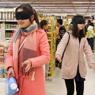 Volunteers attempt to shop blindfolded during an event to mark the International Day of Persons with Disabilities, at a supermarket in Mianyang, Sichuan province, China December 3, 2014.