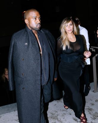 PARIS, FRANCE - SEPTEMBER 29: Kim Kardashian and Kanye West arriving at Givenchy show as part of the Paris Fashion Week Womenswear Spring/Summer 2014, held at 'la Halle Freyssinet' on September 29, 2013 in Paris, France. (Photo by Bertrand Rindoff Petroff/Getty Images)