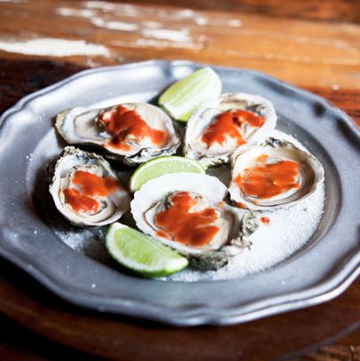 Roasted oysters on the half shell with fermented bean curd, chili, and lime.