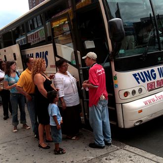 Passengers prepare to load a Fung Wah bus before leaving Manhattan for Boston August 4, 2008 in New York. With fuel prices skyrocking, bus services have seen an increase in ridership in recent months.
