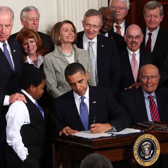 WASHINGTON - MARCH 23: U.S. President Barack Obama signs the Affordable Health Care for America Act during a ceremony with fellow Democrats in the East Room of the White House March 23, 2010 in Washington, DC. The historic bill was passed by the House of Representatives Sunday after a 14-month-long political battle that left the legislation without a single Republican vote. (Photo by Win McNamee/Getty Images)