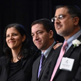 Laura Poitras (L) and Glenn Greenwald (C), in the US for the first time since documents were disclosed to them by former intelligence analyst Edward Snowden, accept Long Island University's George Polk Award for National Security Reporting April 11,2014 in New York. 
