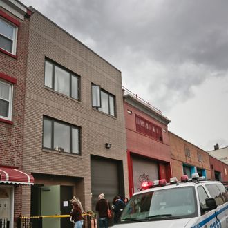 A police vehicle parks outside the location of a Monday shooting rampage, Tuesday, Nov. 12, 2013 in Brooklyn, New York. Police said gunman Ali Akbar Mahammadi Rafie, 29, a musician, killed himself on the roof after shooting to death two members of the Iranian indie rock band Yellow Dogs, a third musician and wounding a fourth person early Monday morning. The shooter was a member of another band from Iran, the Free Keys, who knew the victims but hadn't spoken to them in months because of a 