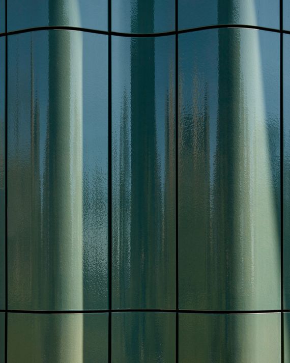 The terra-cotta façade anchors the design in one of New York's great architectural traditions.