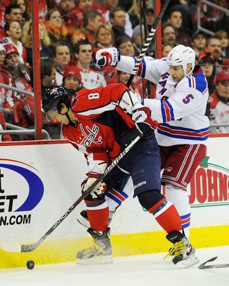 Alex Ovechkin #8 of the Washington Capitals battles for the puck against Daniel Girardi #5 of the New York Rangers