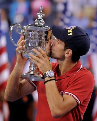 Number one seed Novak Djokovic of Serbia kisses the trophy after his win over number two seed Rafael Nadal of Spain in the men's final at the US Open tennis tournament September 12, 2011 at the Billie Jean King National Tennis Center in New York. Djokovic won 6-2, 6-4, 6-7, 6-1. AFP PHOTO/Stan HONDA (Photo credit should read STAN HONDA/AFP/Getty Images)