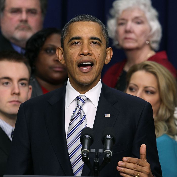 U.S. President Barack Obama speaks in front of workers during an event about the payroll tax cut extension