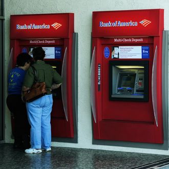 LOS ANGELES, CA - SEPTEMBER 29: A customer uses a Bank of America ATM on September 29, 2011 in Los Angeles, California. Bank of America annouced its plans to start charging a $5 monthly fee for customers using their debit card for purchases starting early in 2012. (Photo by Kevork Djansezian/Getty Images)