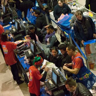 NEW YORK, NY - NOVEMBER 22: People make purchases at the Black Thursday sale at the Toys 'R' Us store in Times Square November 22, 2012 in New York City.The store got a head start on the traditional Black Friday sales by opening their doors at 8pm on Thanksgiving night. (Photo by Andrew Kelly/Getty Images)