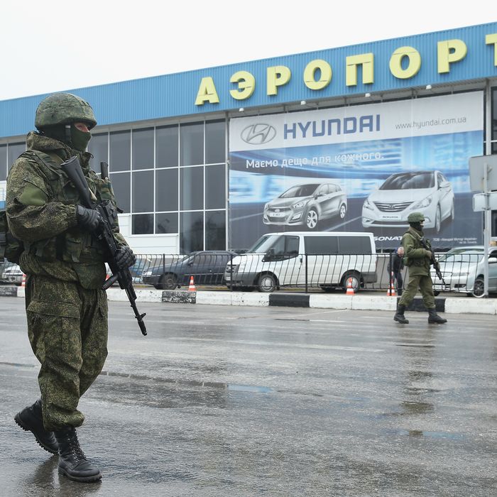 SIMFEROPOL, UKRAINE - FEBRUARY 28: Soldiers, who were wearing no identifying insignia and declined to say whether they were Russian or Ukrainian, patrol outside the Simferopol International Airport after a pro-Russian crowd had gathered on February 28, 2014 near Simferopol, Ukraine. According to media reports Russian soldiers have occupied the airport at nearby Sevastapol in a move that is raising tensions between Russia and the new Kiev government. Crimea has a majority Russian population and pro-Russian men have occupied government buildings in Simferopol. (Photo by Sean Gallup/Getty Images)