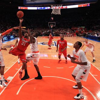 NEW YORK, NY - MARCH 10: Malik Stith #31 of the St. John's Red Storm drives to the basket against James Southerland #43 and Rick Jackson #00 of the Syracuse Orange during the quarterfinals of the 2011 Big East Men's Basketball Tournament presented by American Eagle Outfitters at Madison Square Garden on March 10, 2011 in New York City. (Photo by Chris Trotman/Getty Images) *** Local Caption *** Malik Stith;James Southerland;Rick Jackson