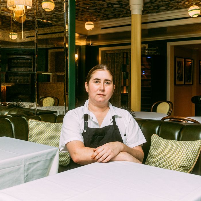 A portrait of chef Ashely Rath sitting at a table the new West Village Italian restaurant Saint Theo's.