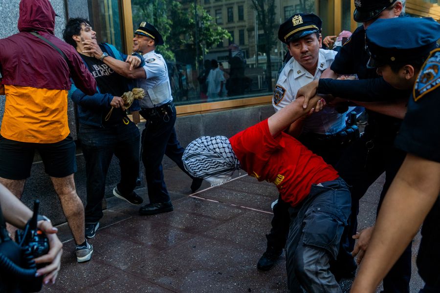 NYPD officers drag multiple protesters away from 26 Federal Plaza on June 7.