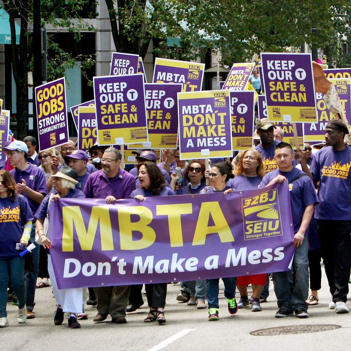 BOSTON - JUNE 21: Service Employees International Union members march in support of MBTA contracted janitors who may loose their jobs because of MBTA cutbacks on Boylston St. in Boston, Mass. on June 21, 2014. (Photo by John Blanding/The Boston Globe via Getty Images)