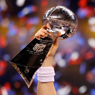 Quarterback Eli Manning #10 of the New York Giants poses with the Vince Lombardi Trophy after the Giants defeated the Patriots by a score of 21-17 in Super Bowl XLVI at Lucas Oil Stadium on February 5, 2012 in Indianapolis, Indiana.