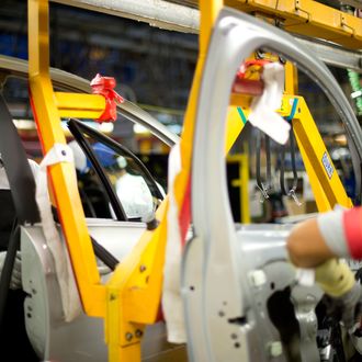 Peugeot's emblems at the assembly line of their new 208 model at Peugeot's factory in Porto Real, 140 Km south of Rio de Janeiro, Brazil on January 30, 2013.