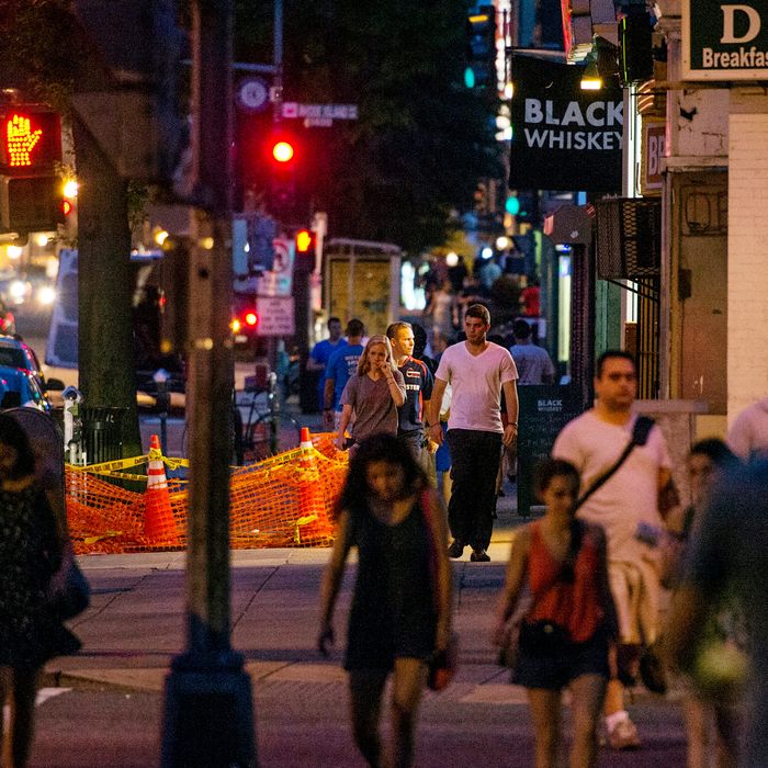 Pedestrians walk up 14th Street NW near Rhode Island Ave. on July 17, 2013 in Washington, D.C. 