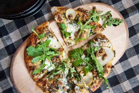 Pear pizza: stracciatella, pear, pecan pesto, arugula, and balsamic.