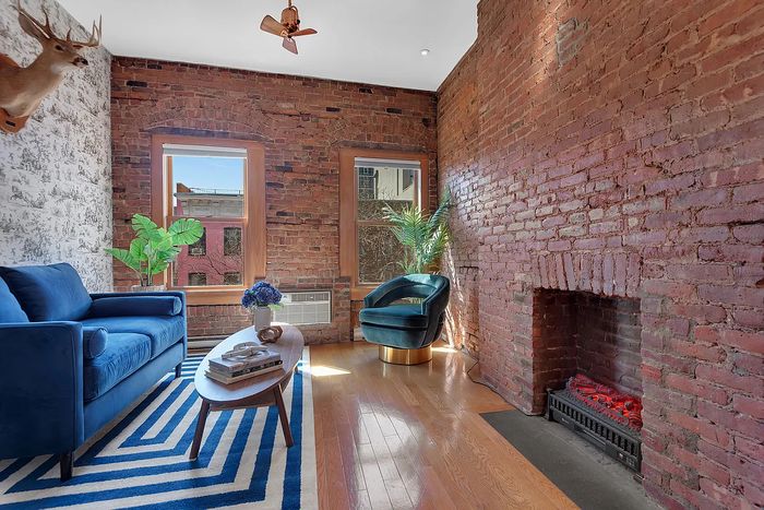 A listing photo showing the living area of a one-bedroom in an East Village apartment