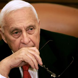 Israeli Prime Minister Ariel Sharon attends a ceremony completing the sale of Bank Leumi to a private US investment group at his office in Jerusalem 04 January 2006. Sharon was at the centre of fresh corruption allegations today, the first scandal to threaten the prospects for his new Kadima party ahead of March general elections. The premier has so far remained tight-lipped over police claims that they may have evidence to prove that the premier's family received a three million dollar bribe from an Austrian billionaire. Police believe some of the money was used by the family to pay back campaign contributions that were subsequently deemed illegal in Sharon's successful 1999 bid to become leader of the right-wing Likud party. AFP PHOTO/POOL/ELIANA APONTE (Photo credit should read ELIANA APONTE/AFP/Getty Images)