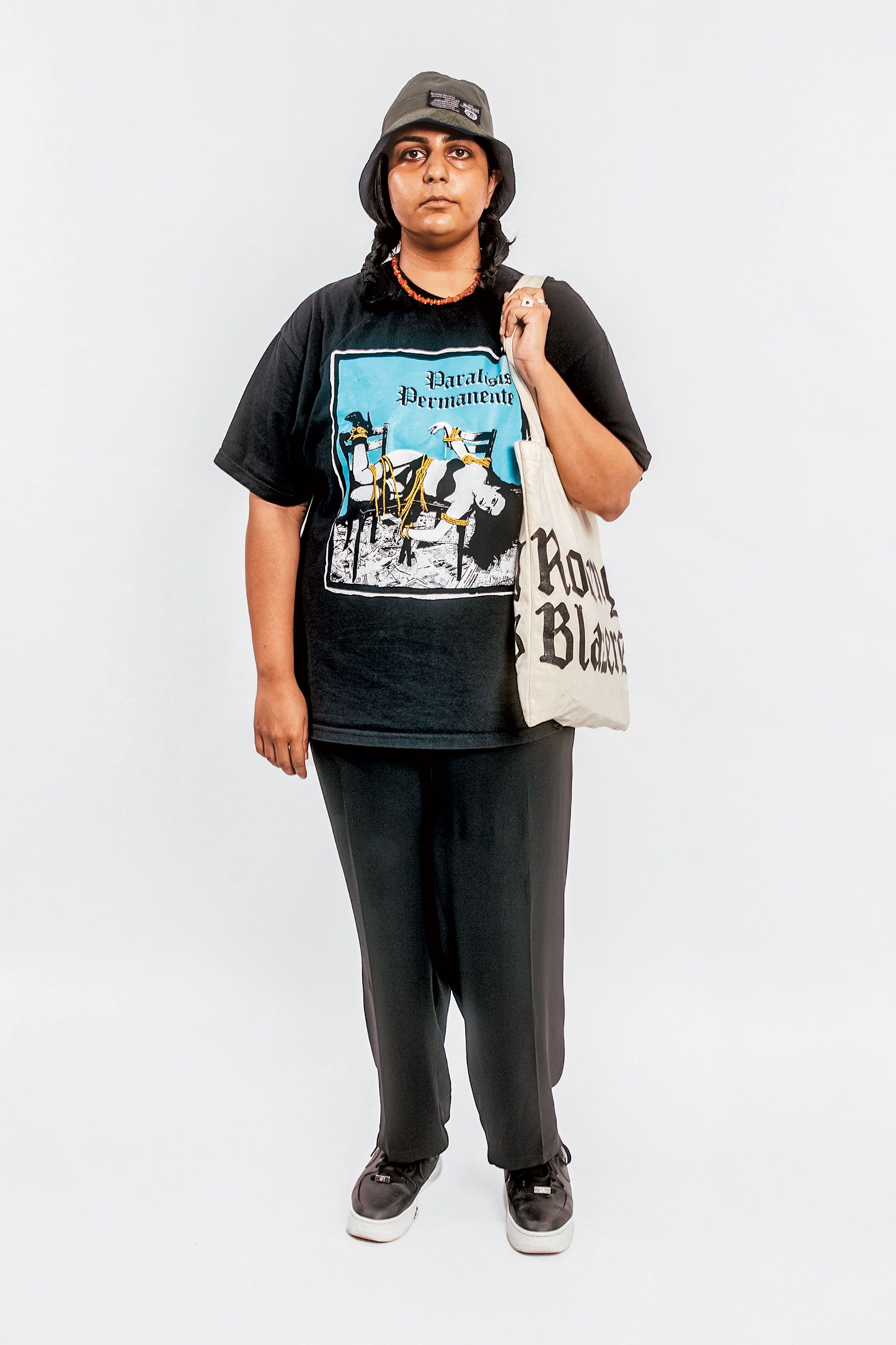 Amrit Dhillon, gallery assistant, Lower East Side: How are people dressing in the neighborhood these days? “I’ve dabbled with things that are maybe trendier, but to me, a big old T-shirt and a hat is true New York LES fashion, way more than a little bag or a silk scrunchie. Same with my street jewelry that turns my hands different colors. Gangrene till I die, bro.”