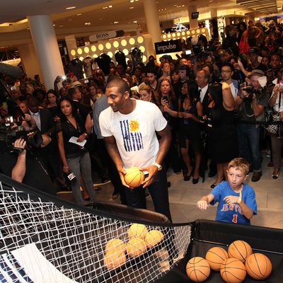 NEW YORK, NY - SEPTEMBER 08: NBA player Amar'e Stoudemire and a youngster shoot hoops to celebrate Fashion's Night Out at Macy's Herald Square on September 8, 2011 in New York City. (Photo by Taylor Hill/Getty Images for Macy's)