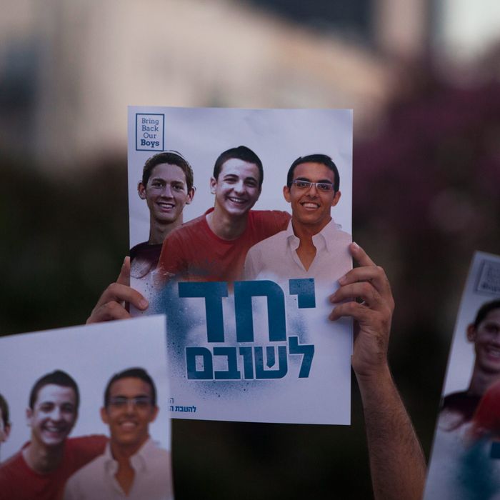 Israelis hold a poster showing the three missing Israeli teenagers, as they attend a rally under the slogan 'Bring Our Boys Home' on June 29, 2014 in Tel Aviv, Israel.
