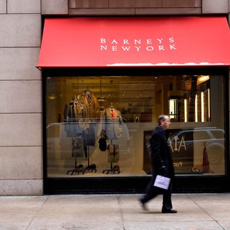 A pedestrian walks past a window display at Barneys New York department store in New York, U.S., on Thursday, Jan. 22, 2009.