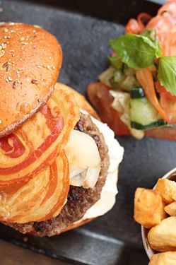 Eight-ounce beef patty with pancetta, sweet-and-sour onions, and Provolone cheese. Served with a cucumber, tomatoes, red-onion salad, and French fries. $16