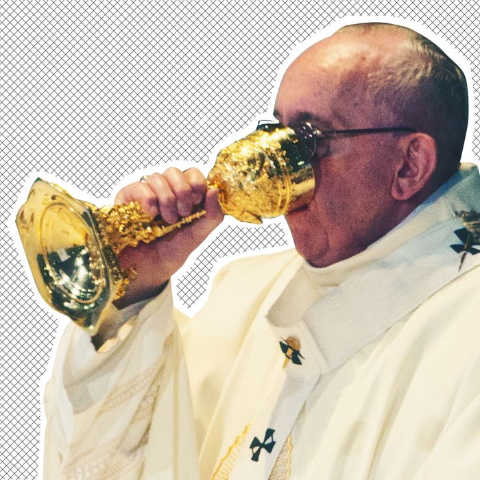 Pope Francis drinking out of a chalice.