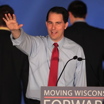 WAUKESHA, WI - JUNE 05: Wisconsin Governor Scott Walker greets supporters at an election-night rally June 5, 2012 in Waukesha, Wisconsin. Walker, only the third governor in history to face a recall election, defeated his Democrat contender Milwaukee Mayor Tom Barrett. Opponents of Walker forced the recall election after the governor pushed to change the collective bargaining process for public employees in the state. (Photo by Scott Olson/Getty Images)