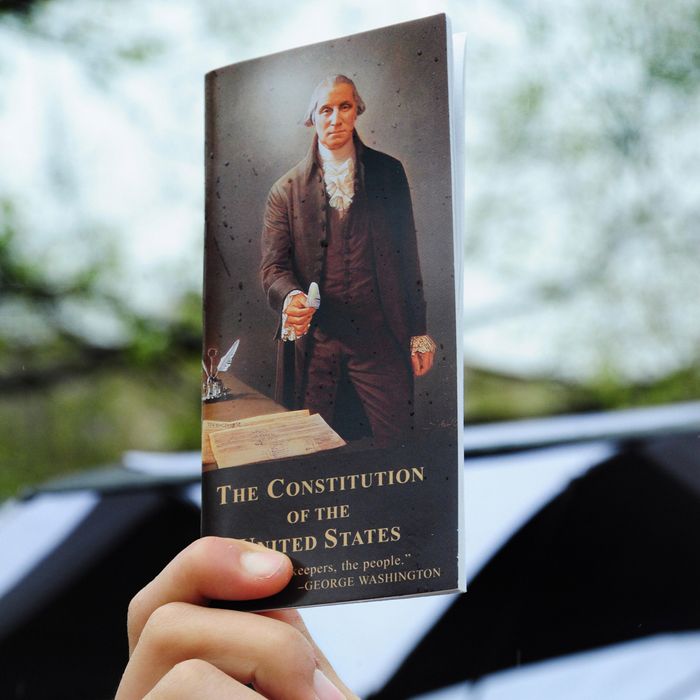 A protester hold a copy of the US Constitution during a