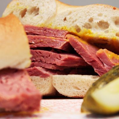 Salt beef, which is really corned beef, on a bagel with yellow deli mustard.