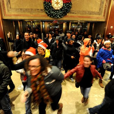 Oddly cheerful stampeding shoppers at Macy's on Black Friday.