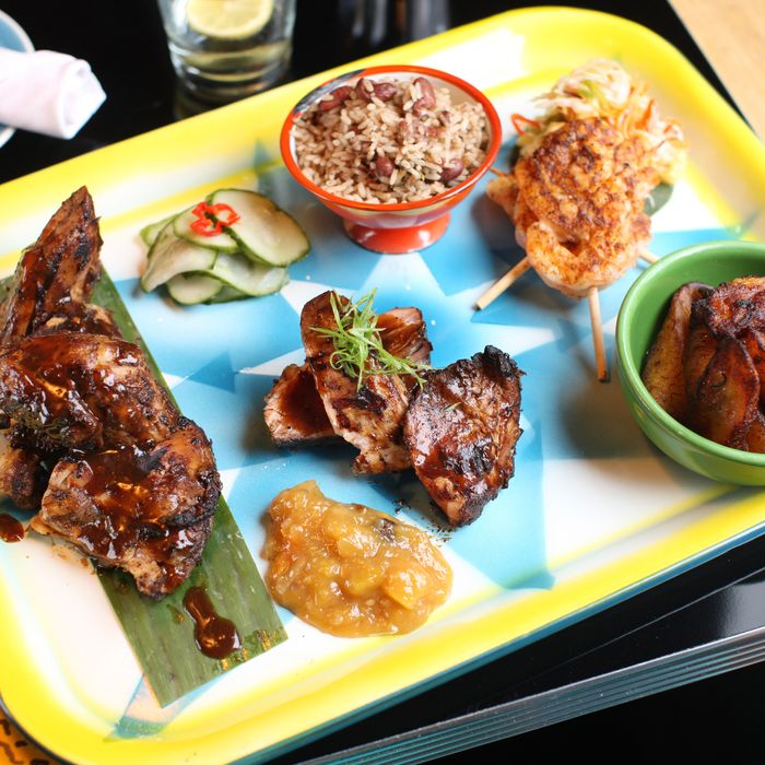 Jerk chicken, pork, and shrimp with rice and peas, charred pineapple slaw, sweet plantains, and mango chutney.