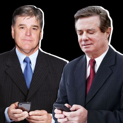 Sean Hannity and Paul Manafort, each holding cell phones.