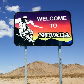 Desert Highway in Nevada with Welcome Sign